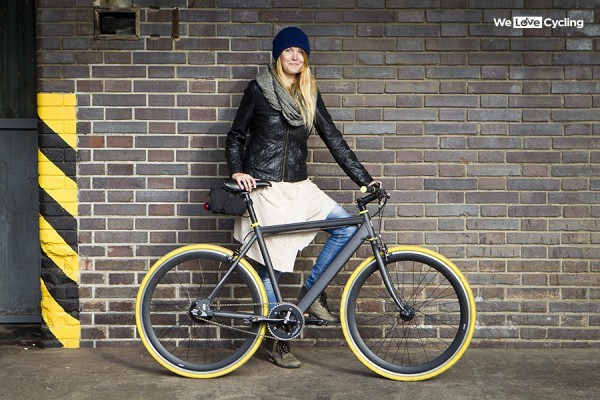 BH Easy Go Race e bike being held by a woman in jeans and a black leather jacket